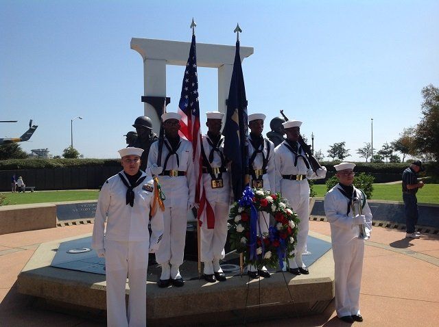 sailors in front of monument