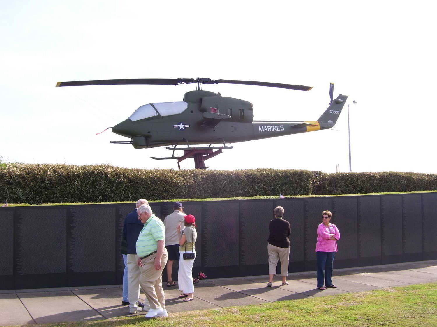 group in front of helicopter