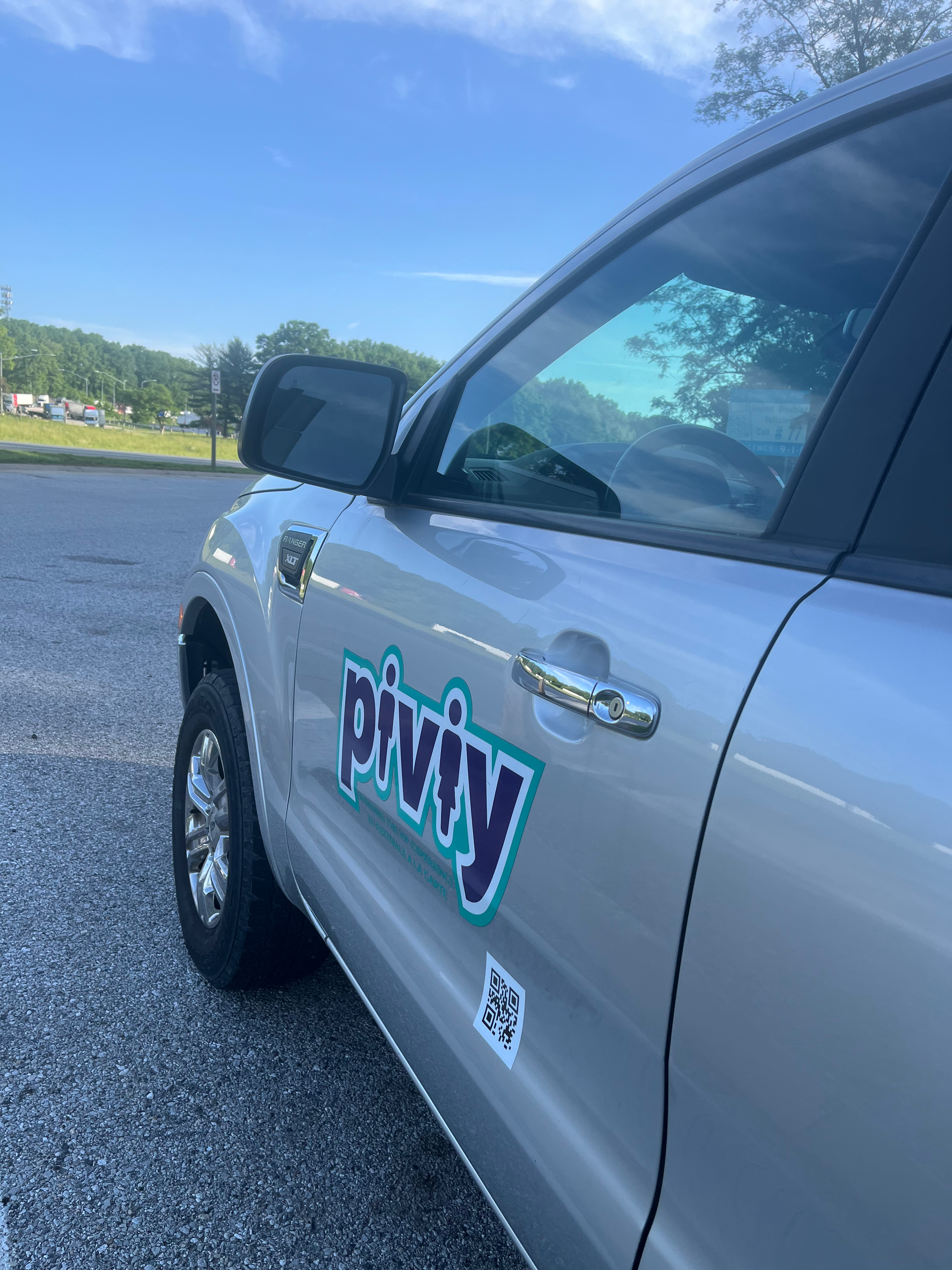 A silver car with the word piviv on the side