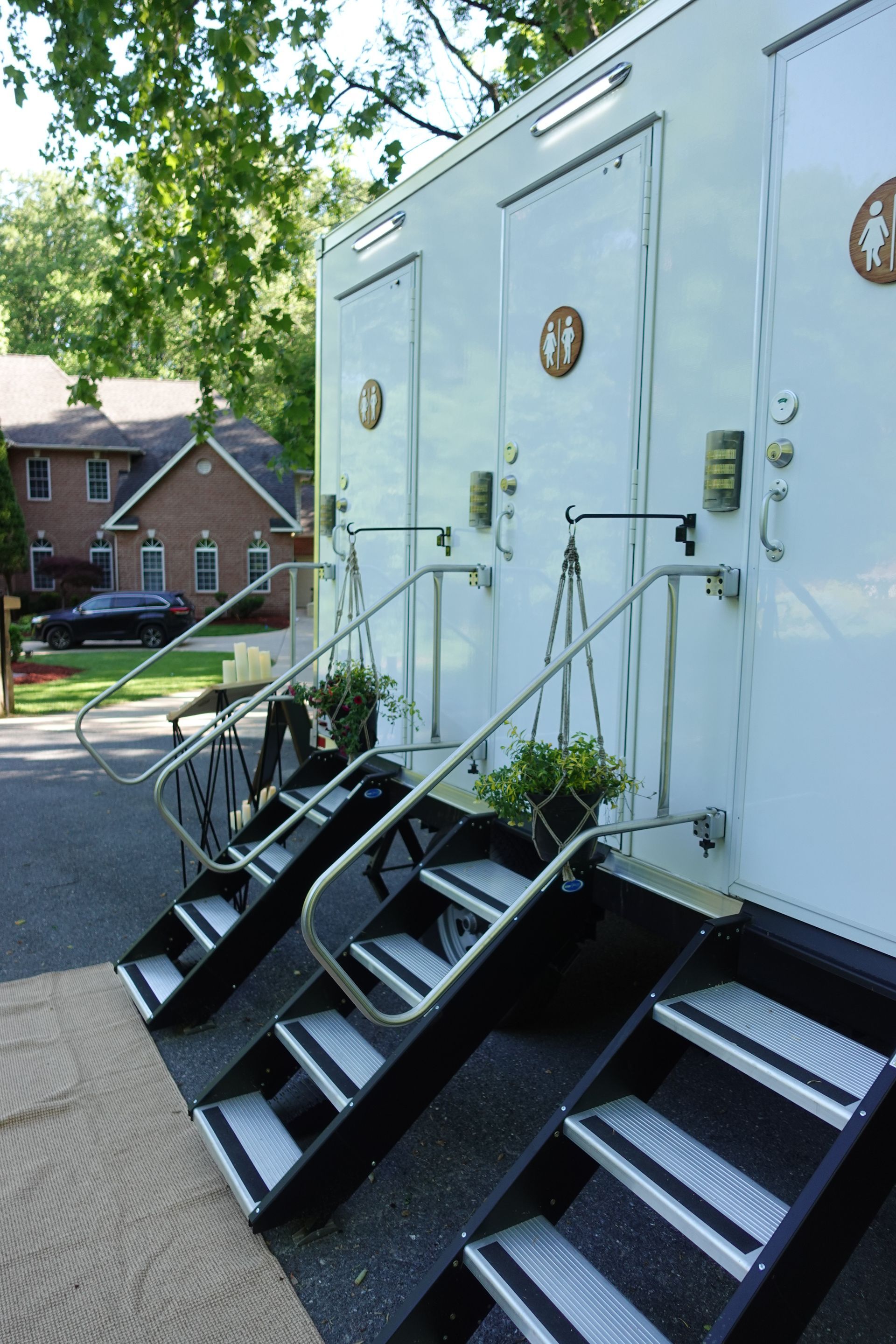 A row of white trailers with stairs leading up to them
