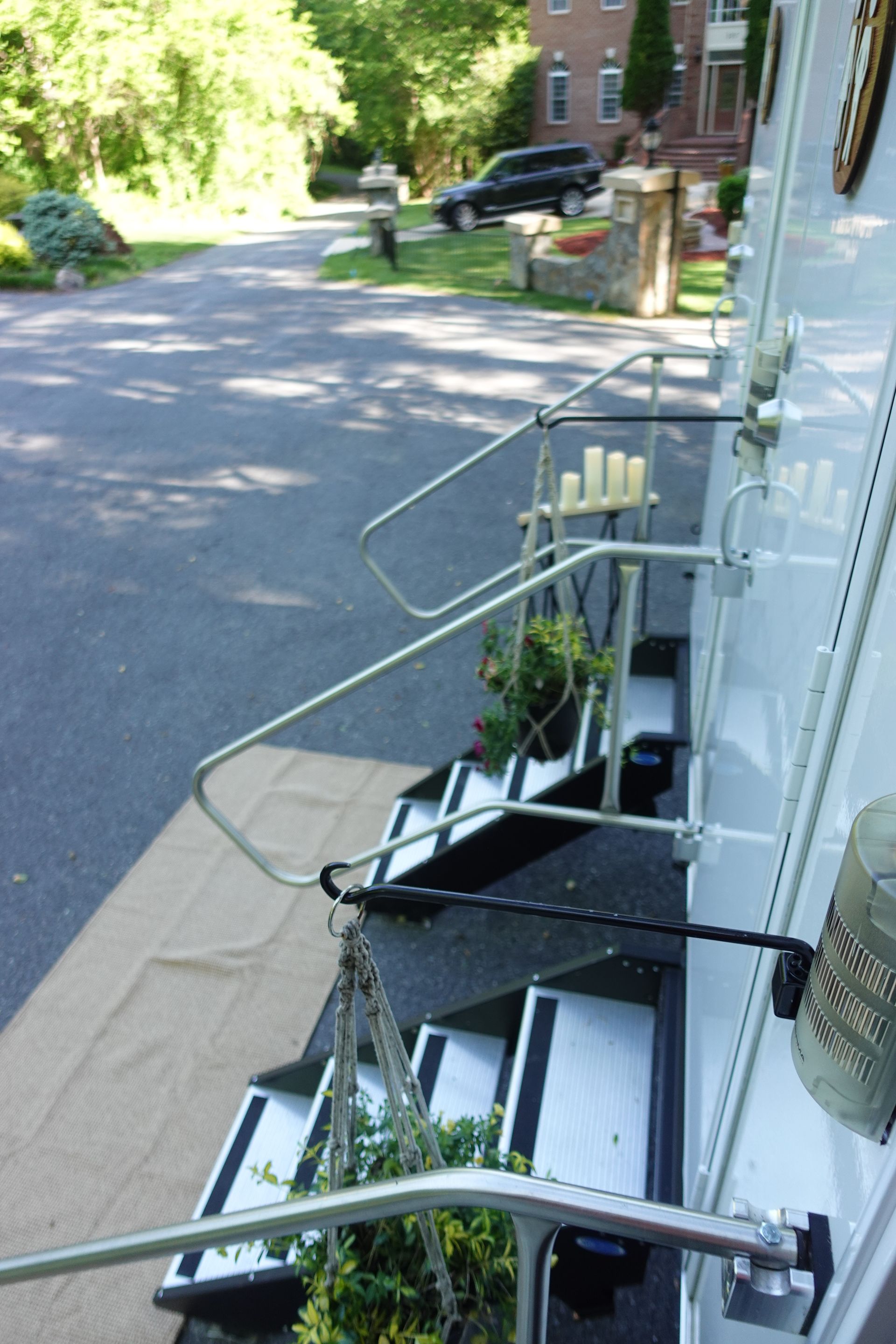 A staircase with a railing and candles hanging from it
