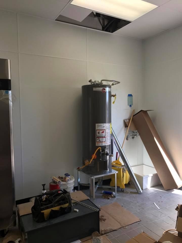 There is a water heater in the middle of the room.