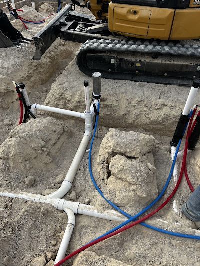 A construction site with pipes and a bulldozer in the background.