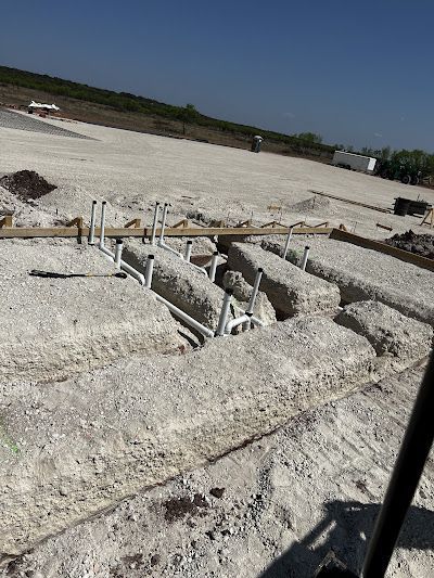 A construction site with a lot of holes in the ground.