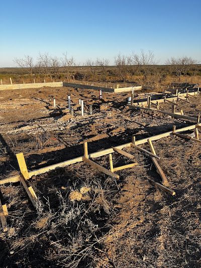A fence is being built in the middle of a field.