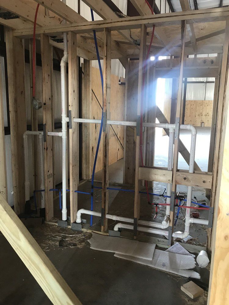 A room under construction with a lot of pipes in it