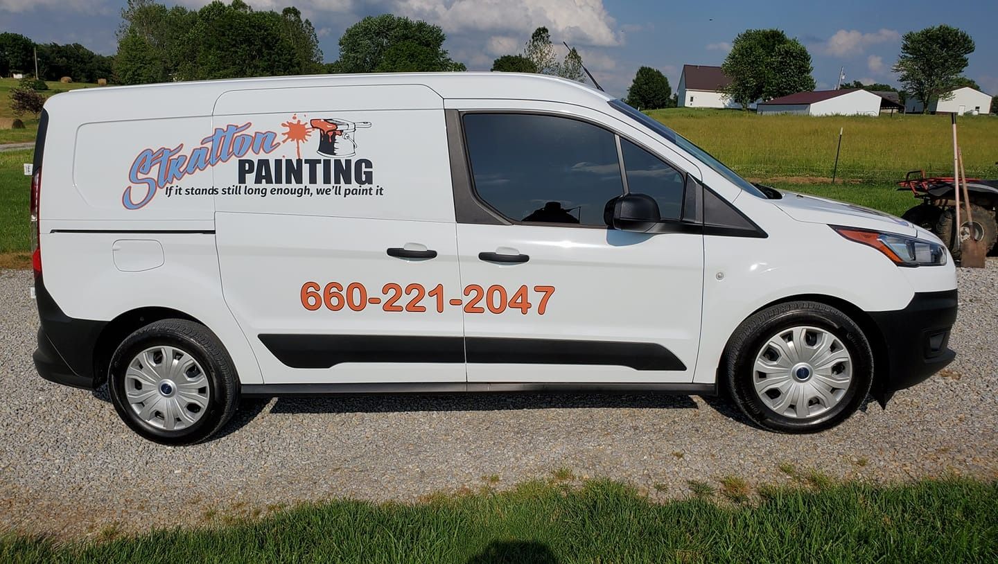 White work van parked on gravel, featuring the Stallion Painting logo and phone number 660-221-2047 on the side.