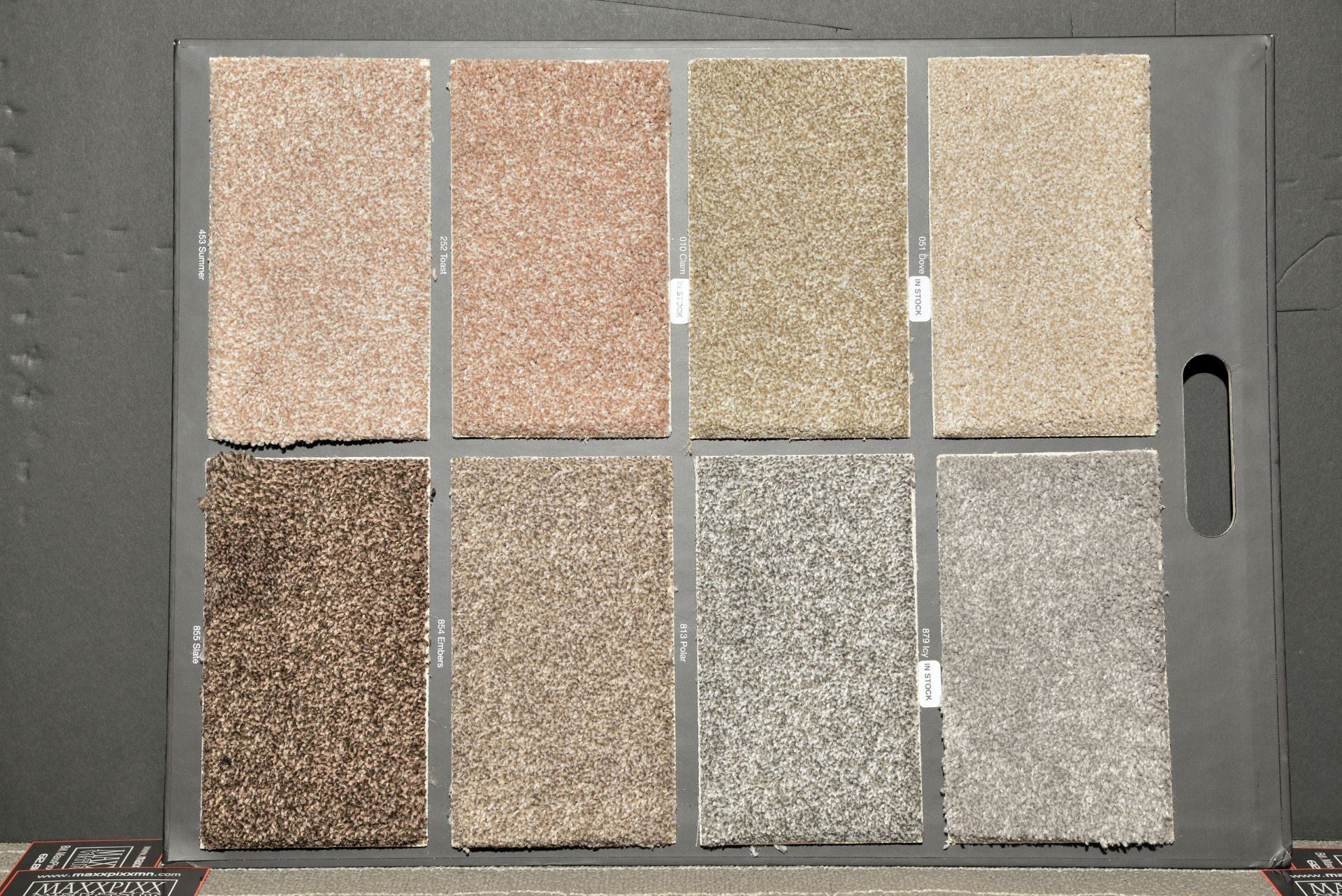 A tray of different colored carpet samples