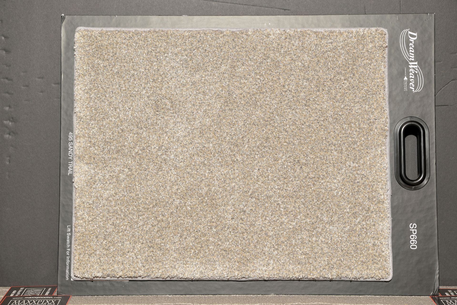 A piece of carpet is sitting on top of a black table.