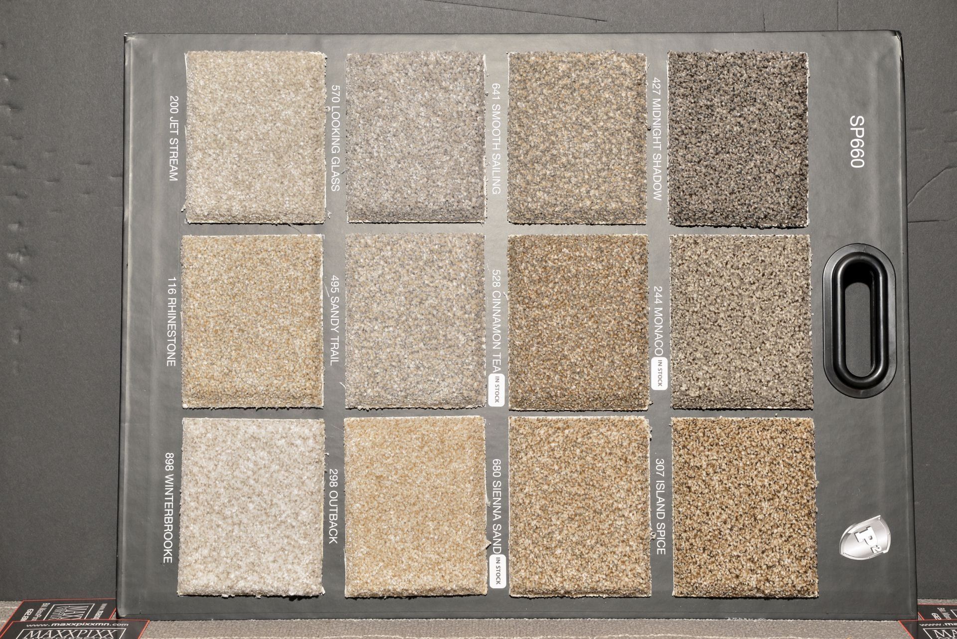 A variety of carpet samples are displayed on a table