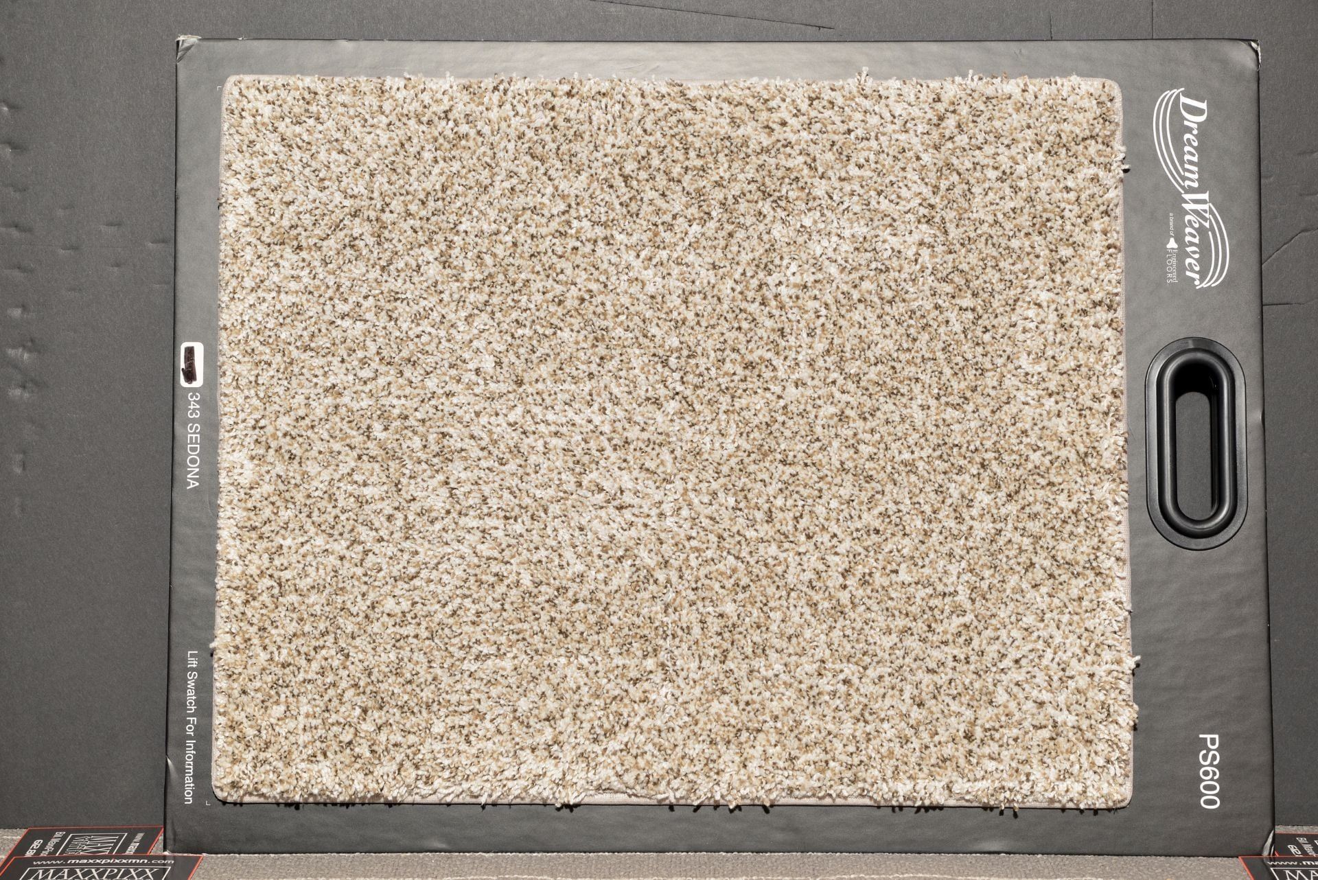 A piece of carpet is sitting on a black surface