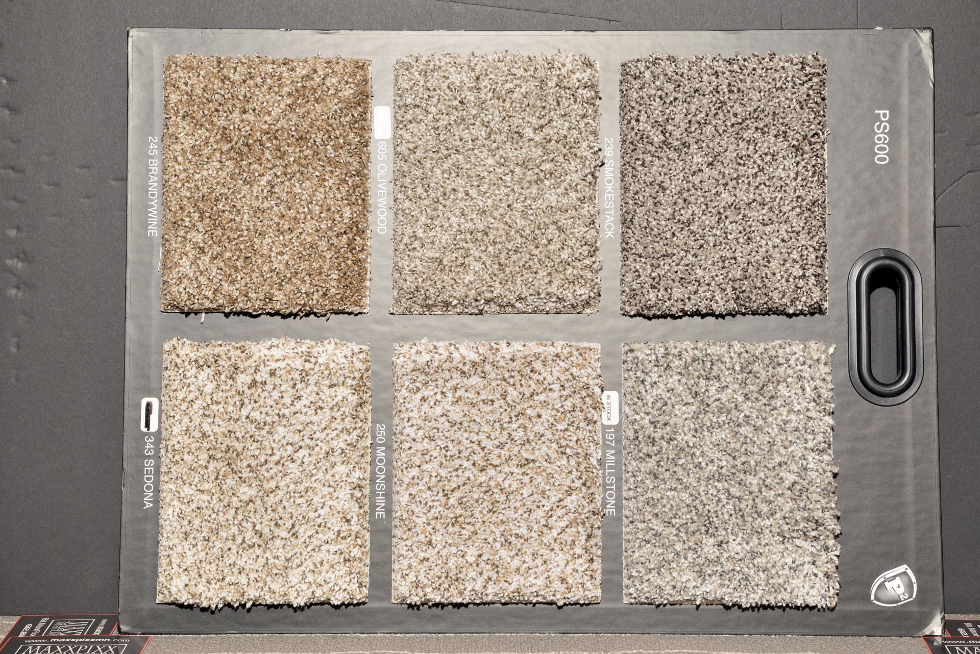 A carpet swatch board shows different shades of carpet