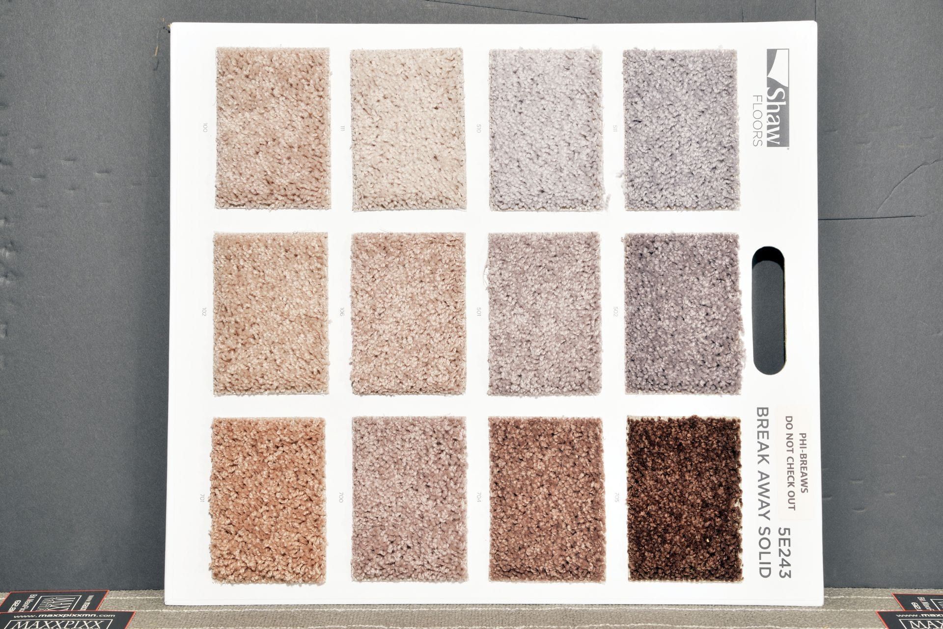 A carpet swatch display shows different shades of brown