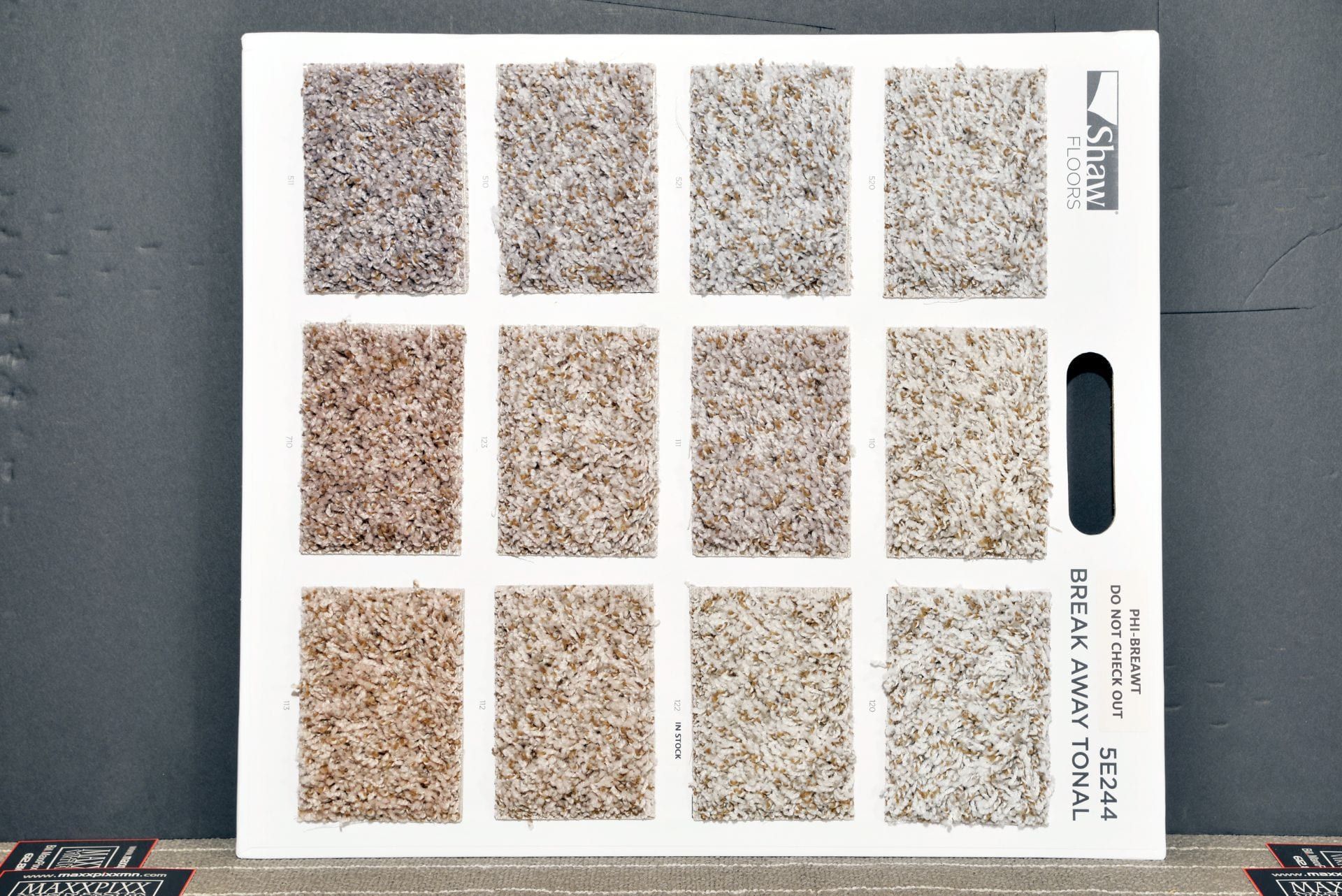 A carpet swatch board shows a variety of carpet colors