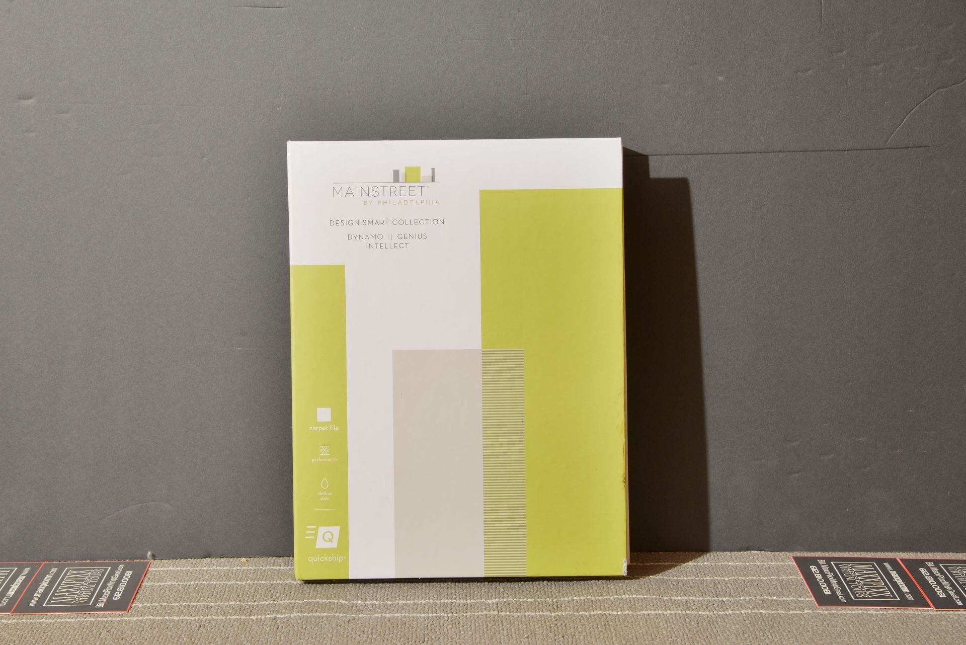 A green book is sitting on a table in front of a wall