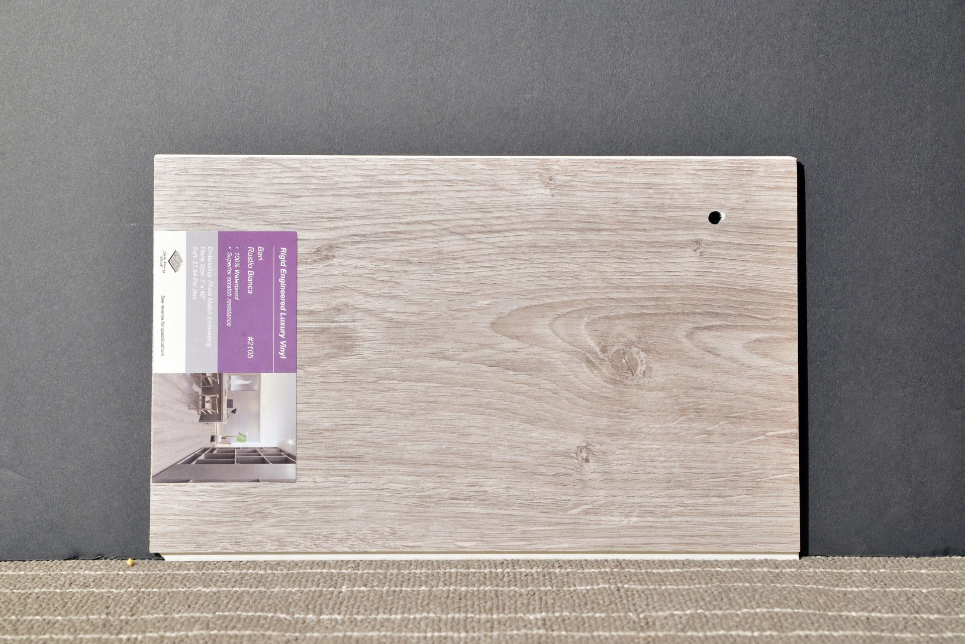 A piece of wood with a purple label on it