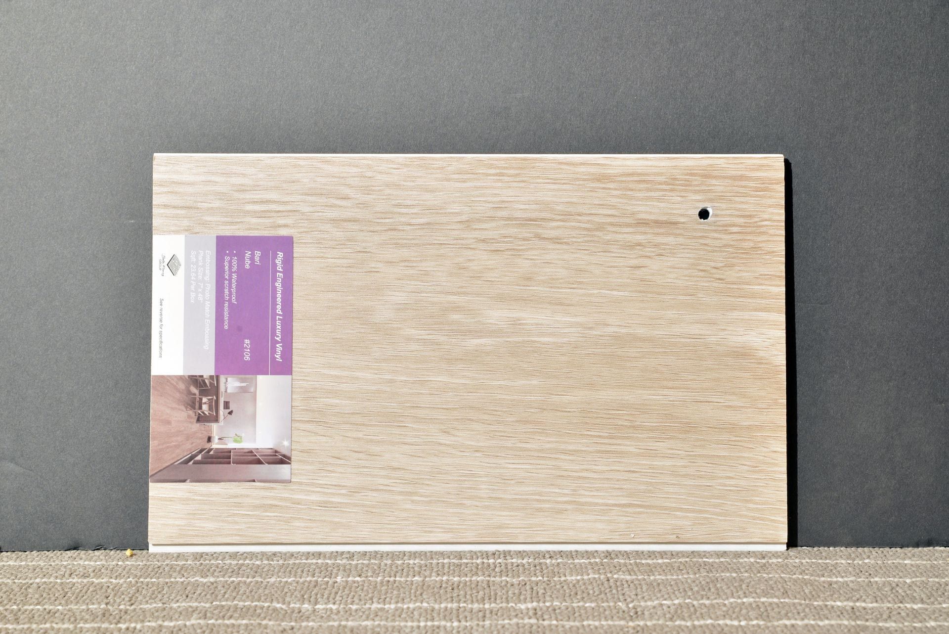 A piece of wood with a purple label on it