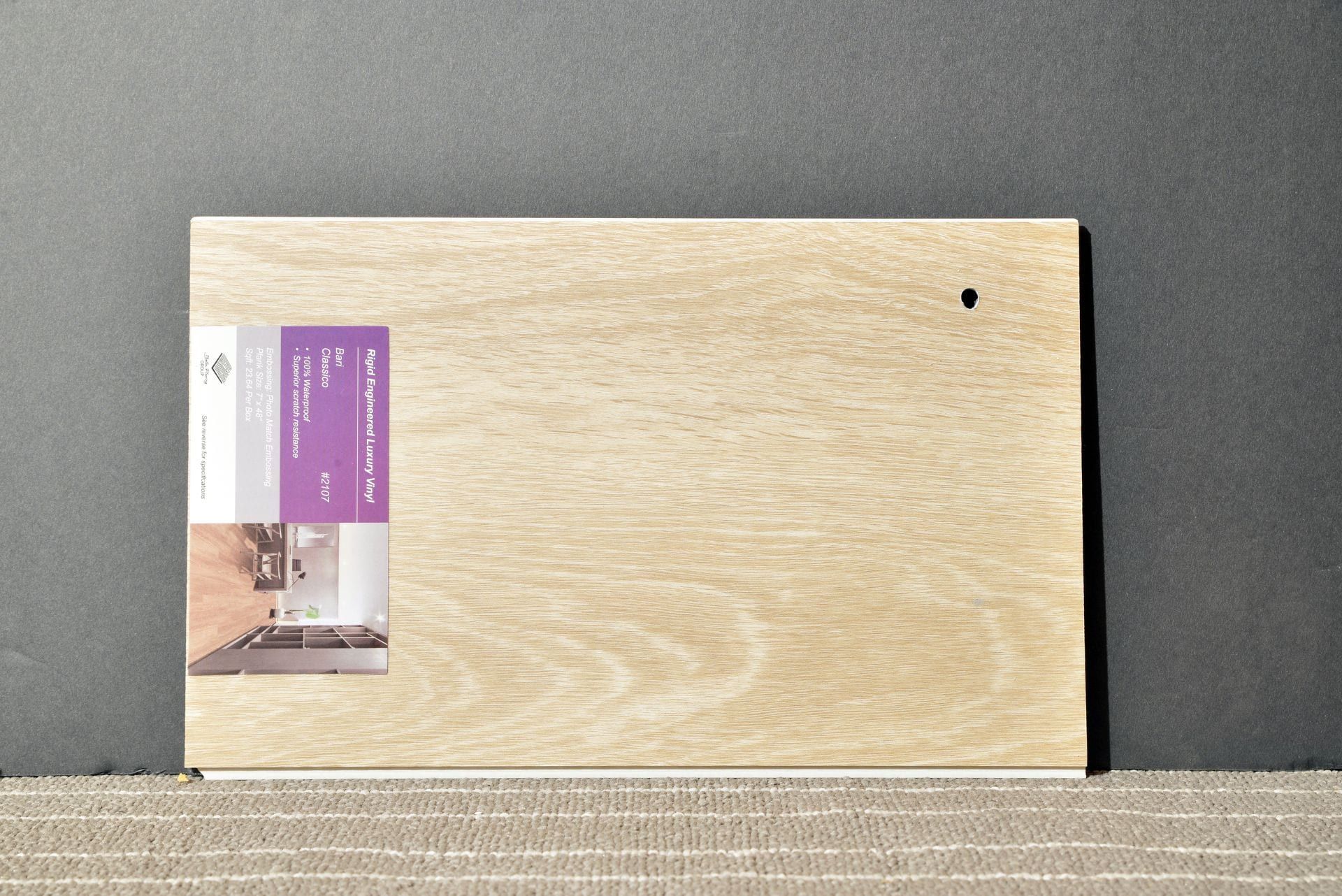 A piece of wood with a purple label on it