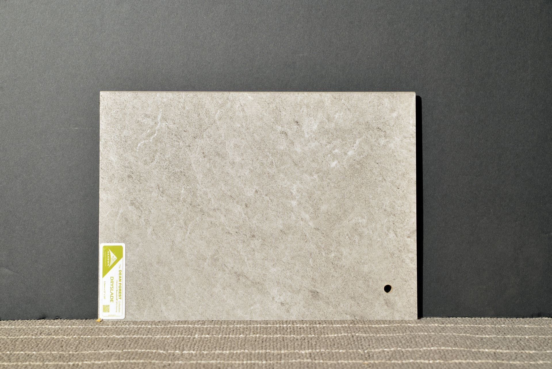 A piece of concrete with a hole in the middle is sitting on a table.