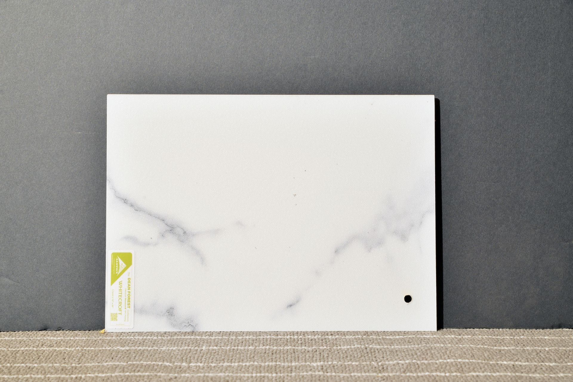 A white card with a hole in the middle is sitting on a table.