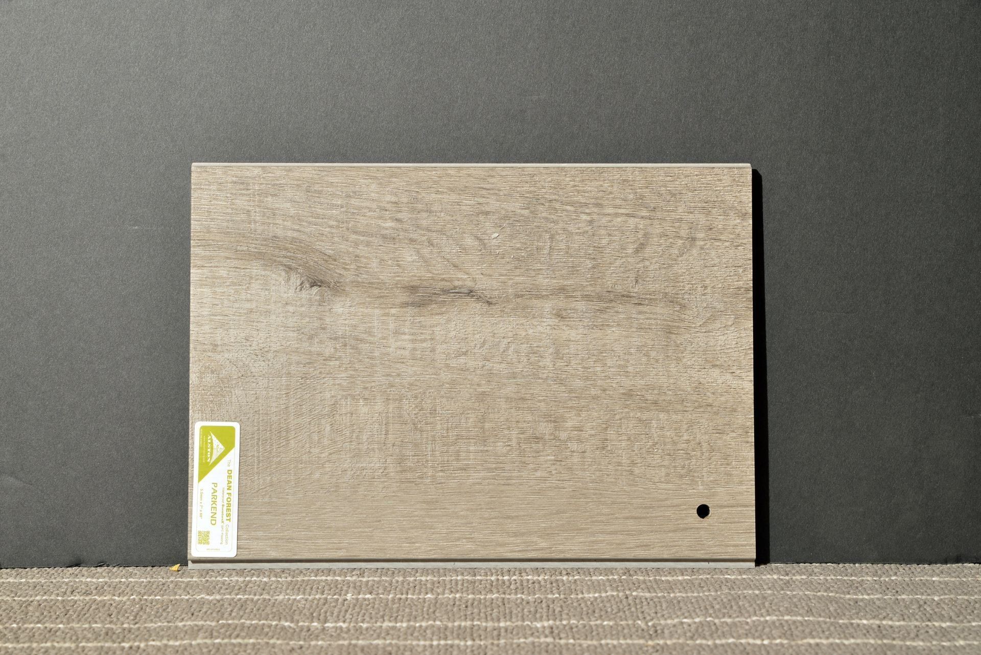 A piece of wood is sitting on top of a black surface.