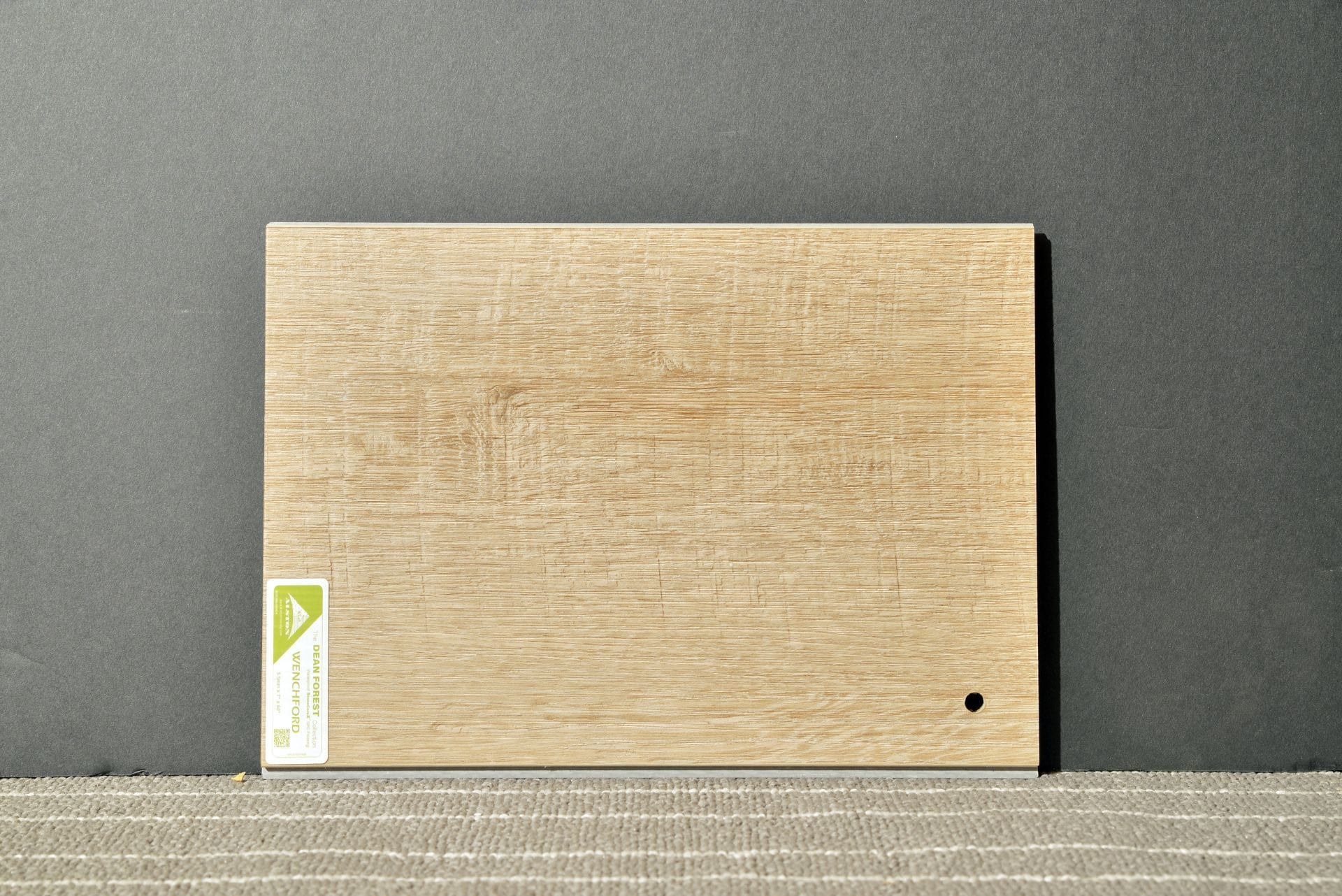 A piece of wood is sitting on a table next to a wall.