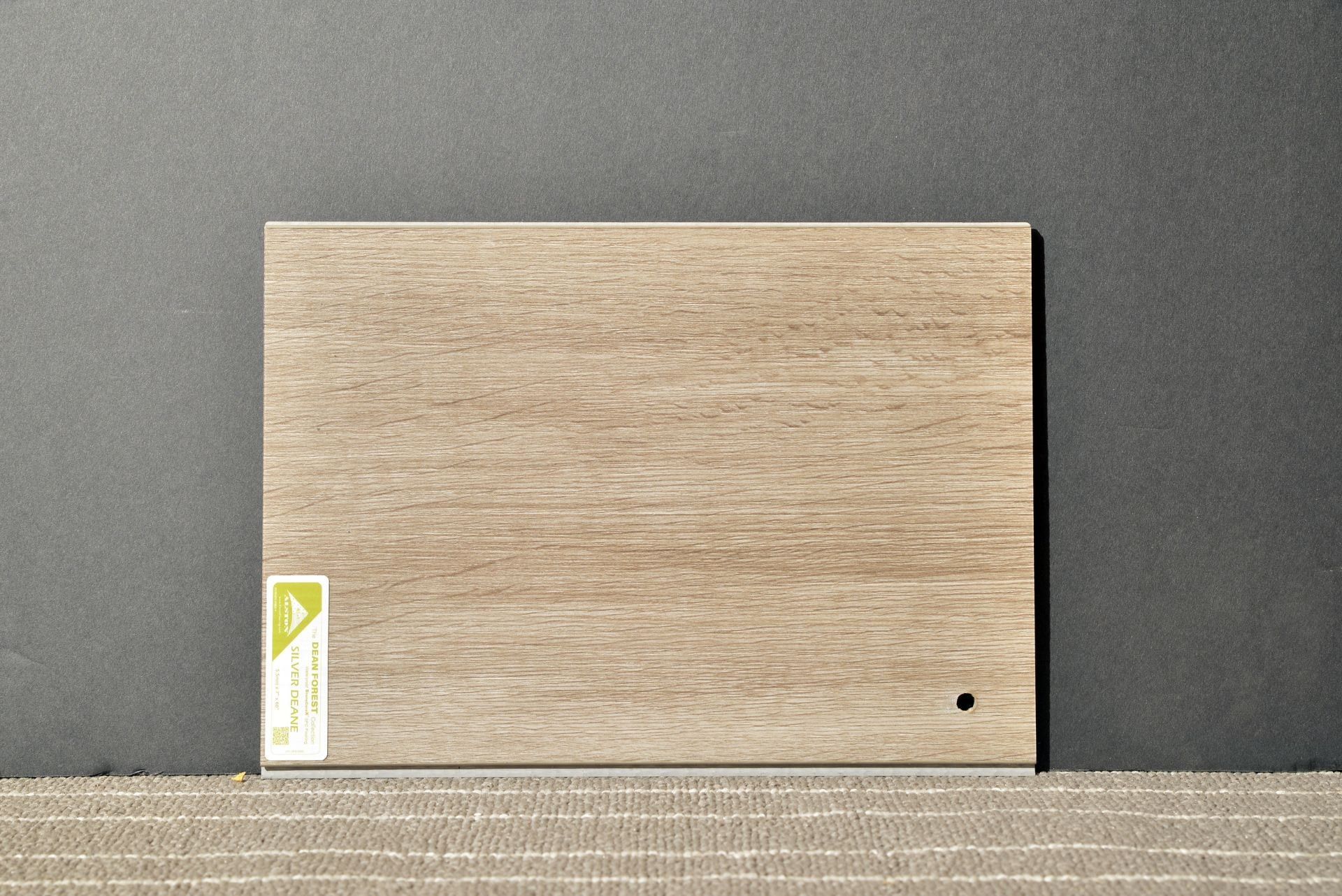 A piece of wood with a hole in it is sitting on a table.