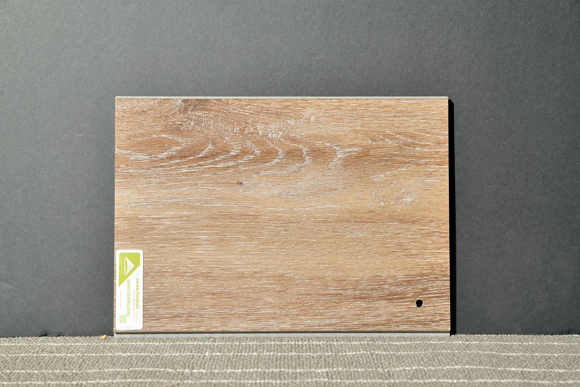 A piece of wood with a green label on it