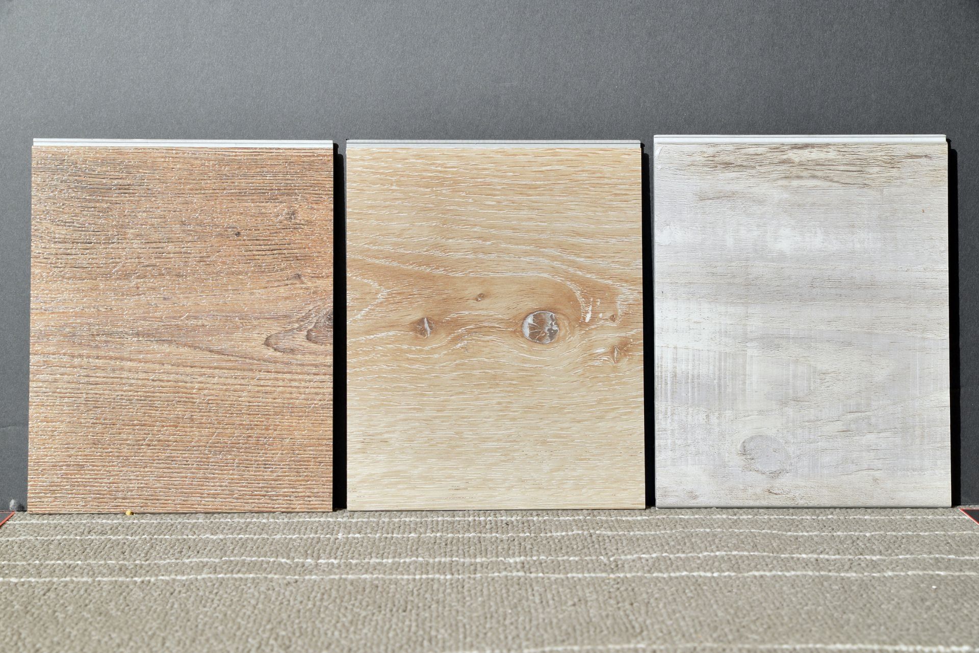 Three different types of tiles are lined up on a table