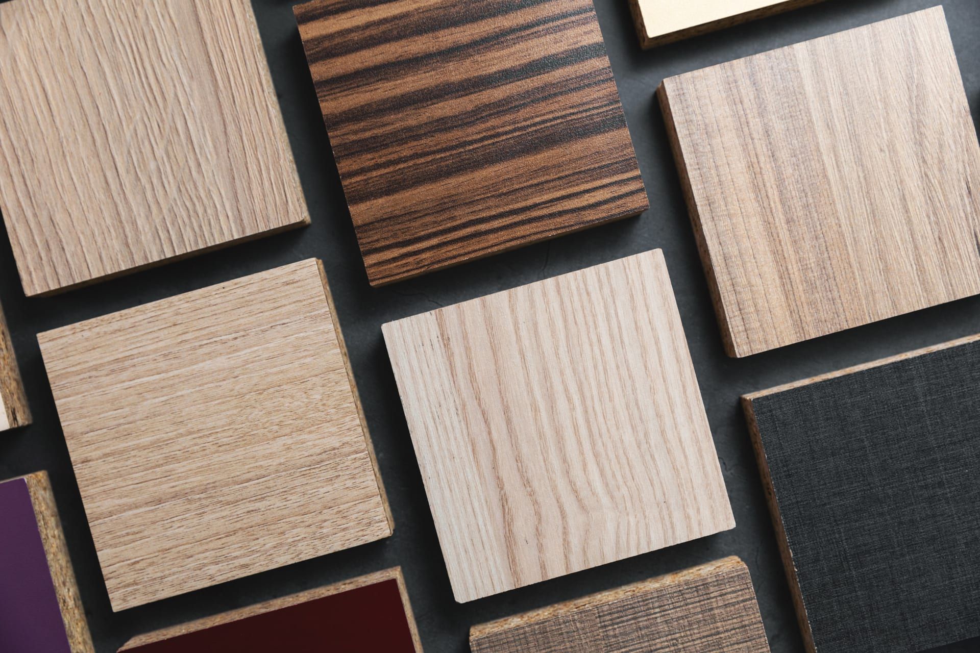 There are many different types of wood samples on the table.