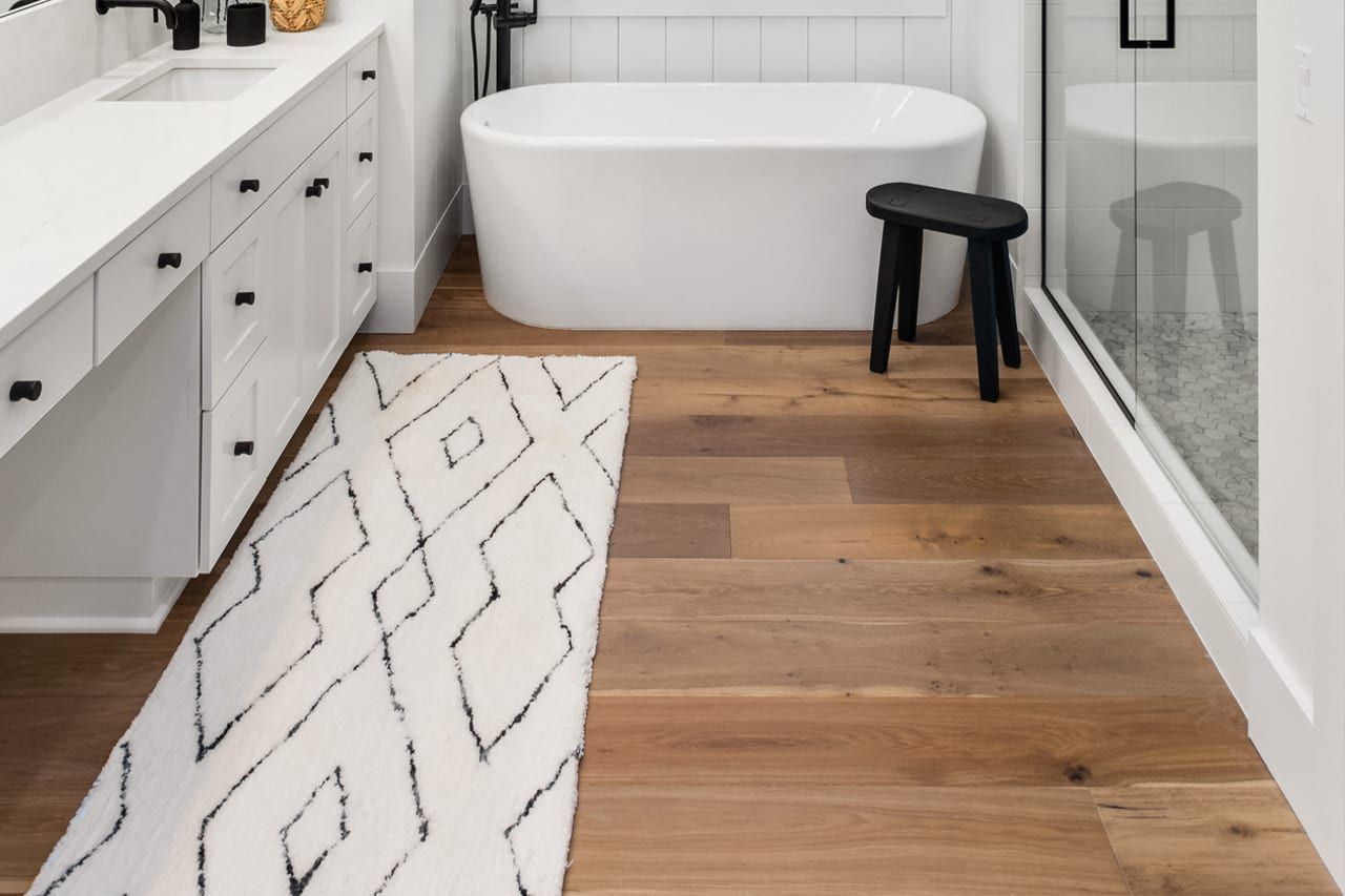 A bathroom with a bathtub, sink, and shower.