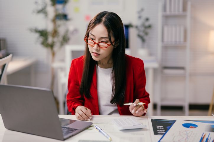 Woman working on financials at her desk