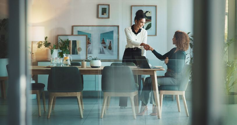 Two business women shaking hands
