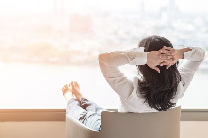 Woman relaxing in a comfortable chair in the sun