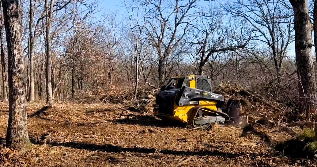 Land clearing equipment in action, clearing trees and brush for development purposes