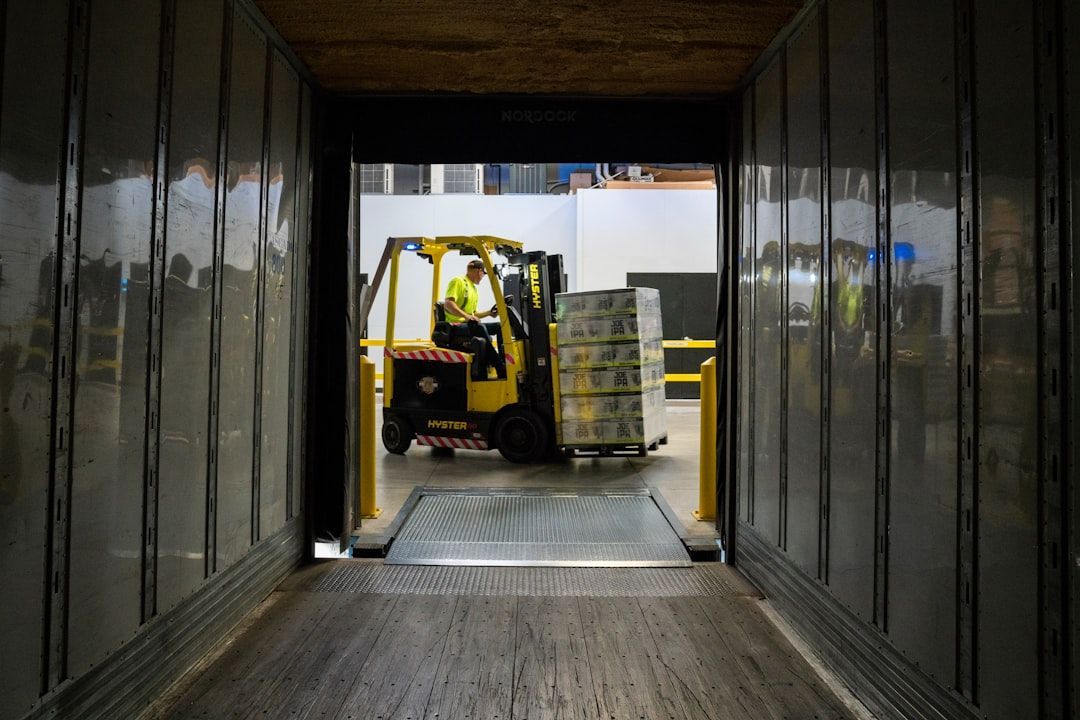 A forklift is loading boxes into a warehouse.