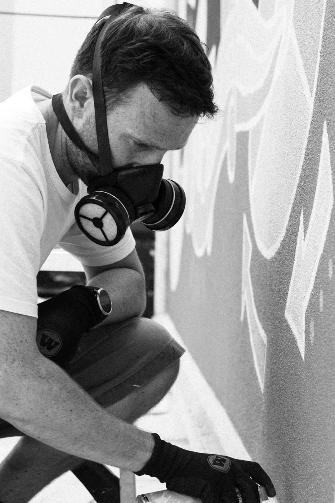 A black and white photo of a man wearing a gas mask