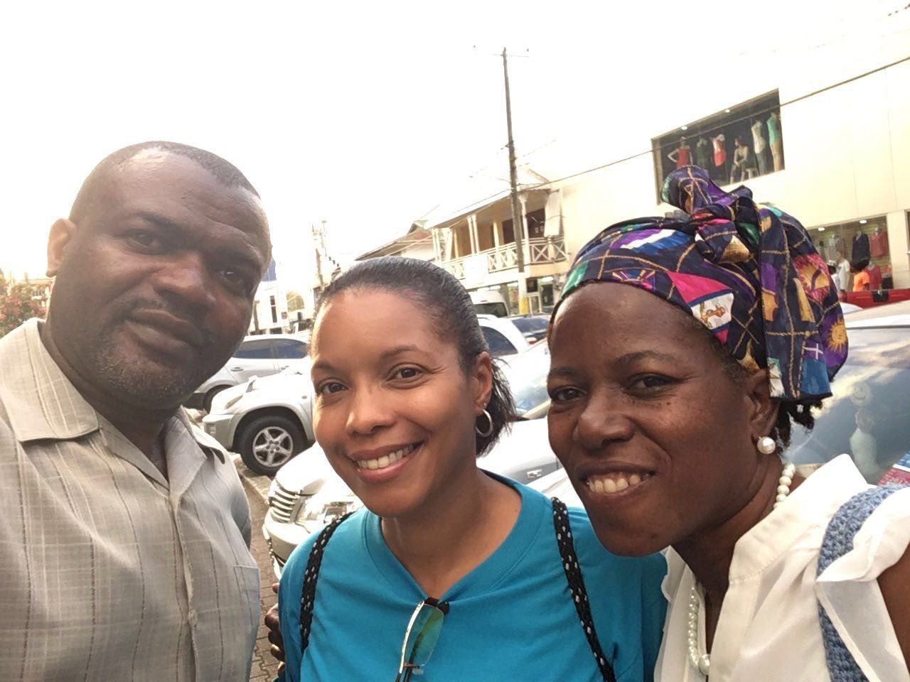 A man and two women are posing for a picture together.