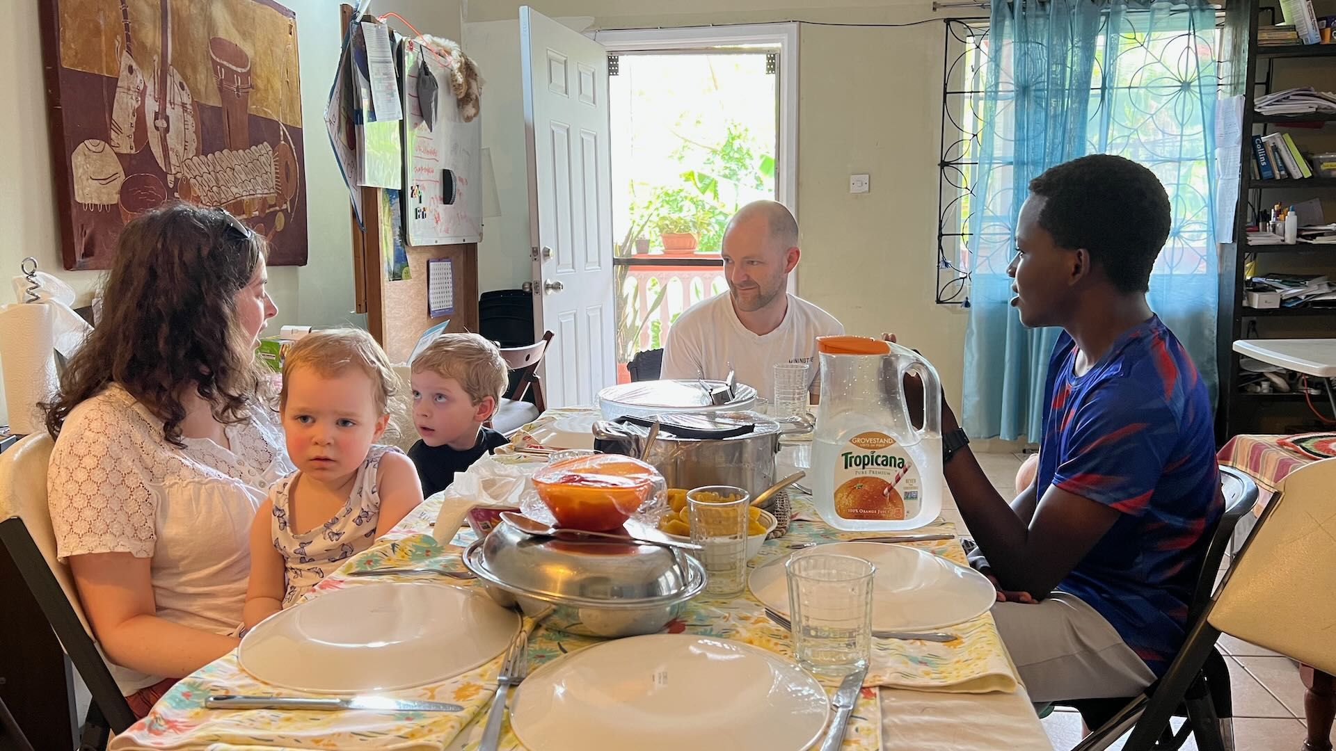 With out family sitting around a table eating food.