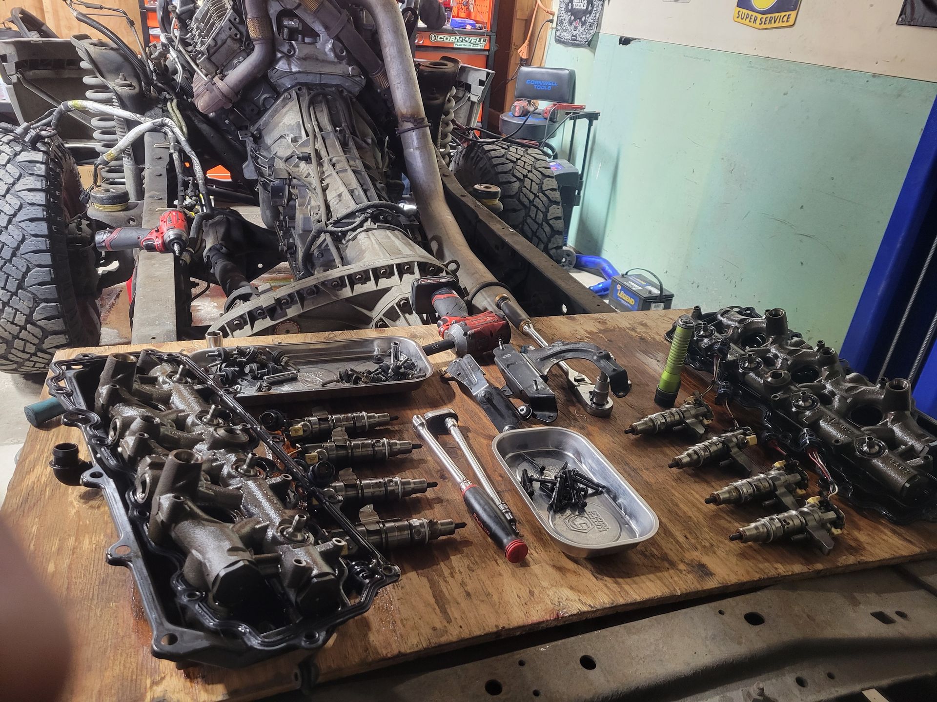 Engine components laid out on a wooden surface | Countryside Automotive