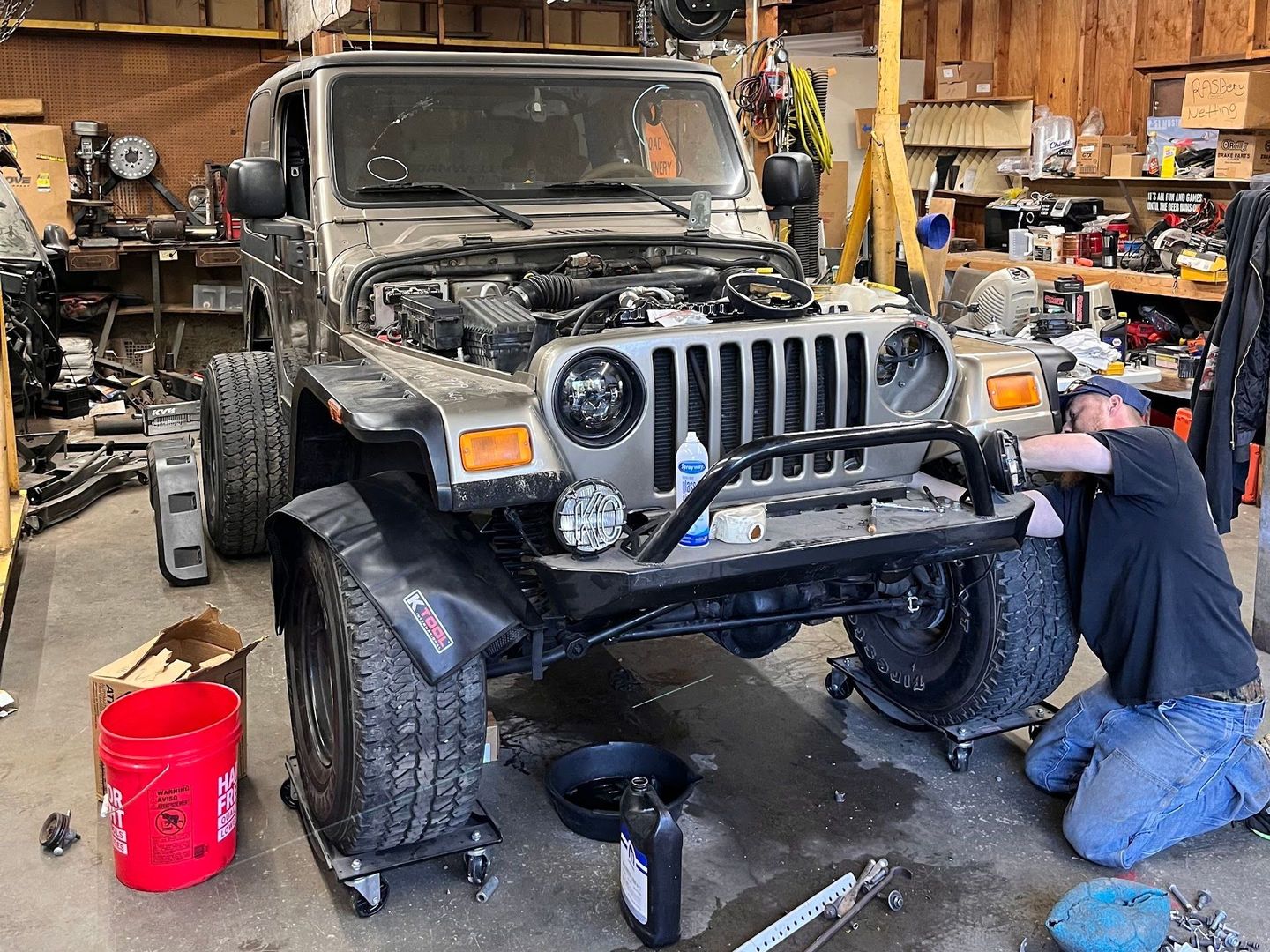 Mechanic Working on Jeep Wrangler Front Suspension in Auto Repair Shop | Countryside Automotive