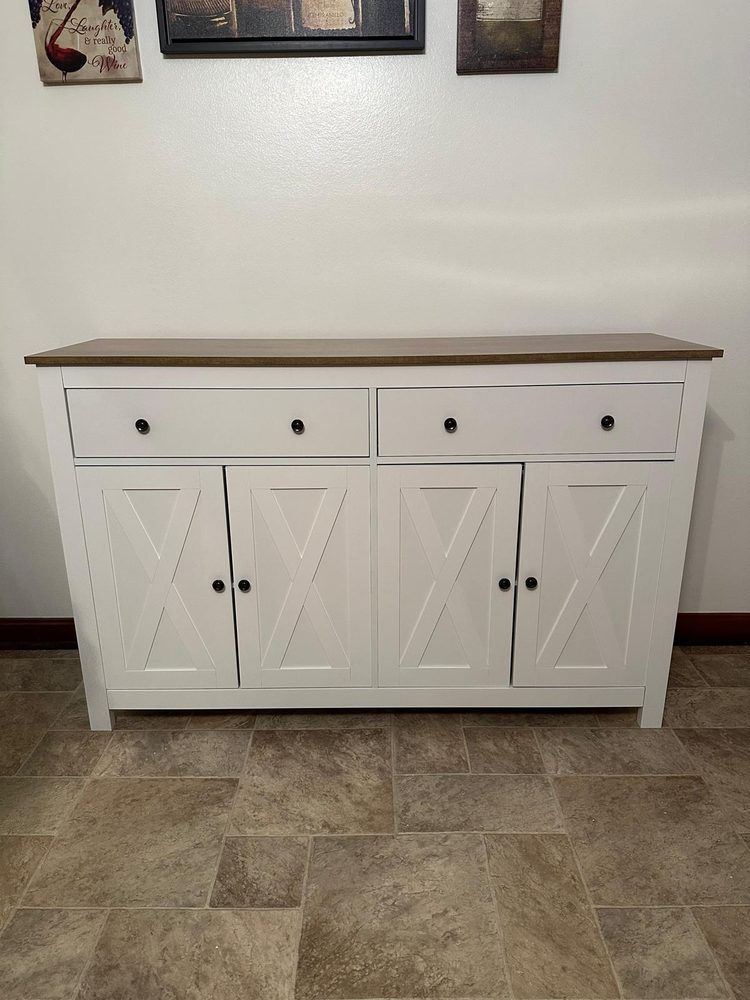 A white dresser with drawers and doors is sitting on a tiled floor in a living room.