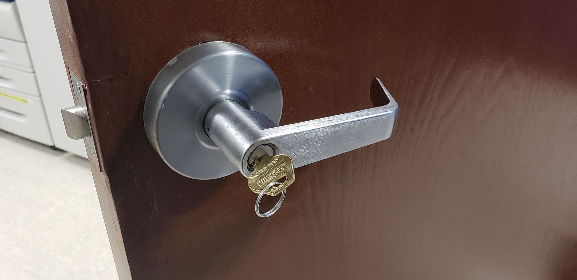 A close up of a door lock with a key in it