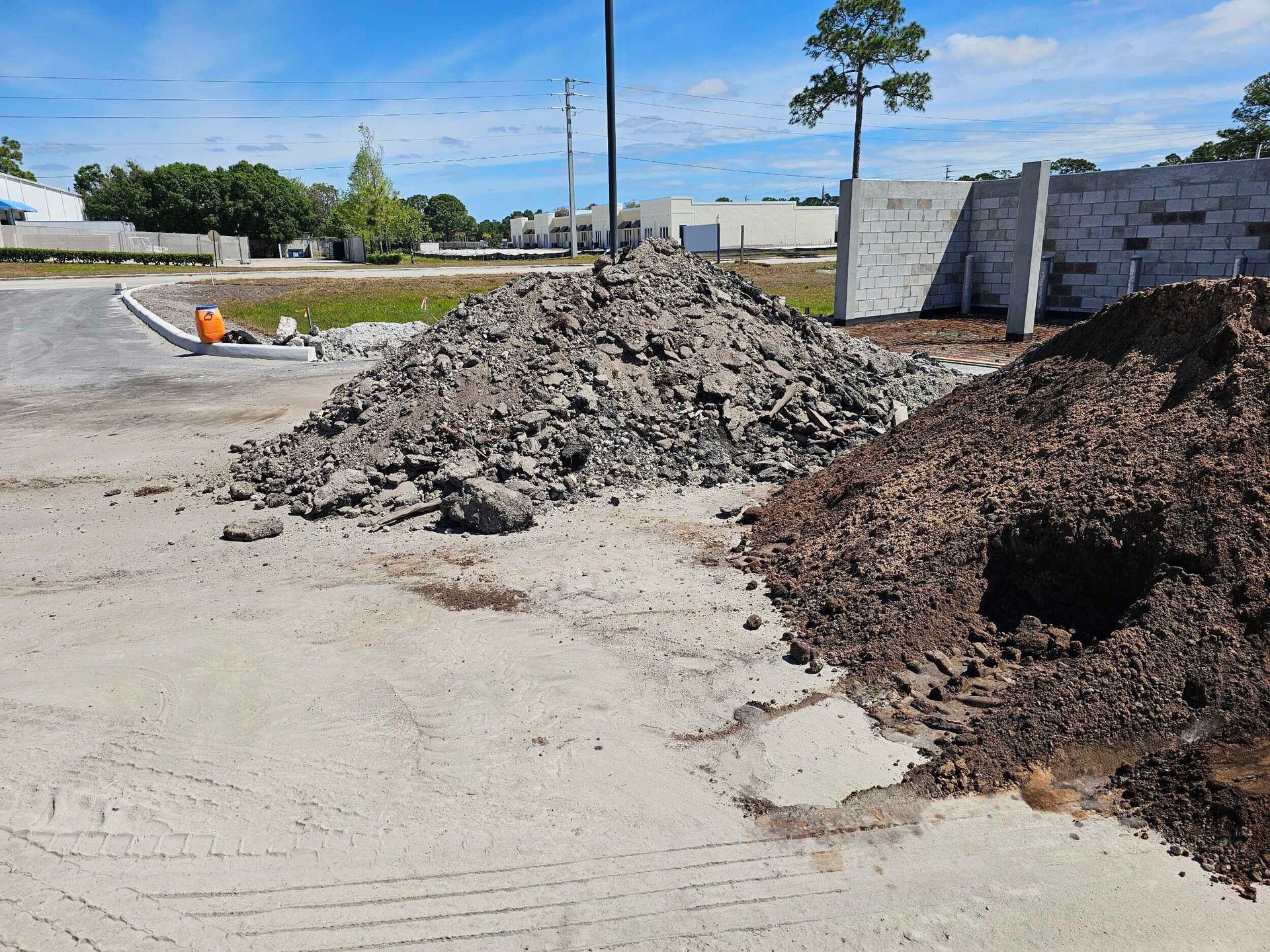 A pile of dirt is sitting on the side of a road
