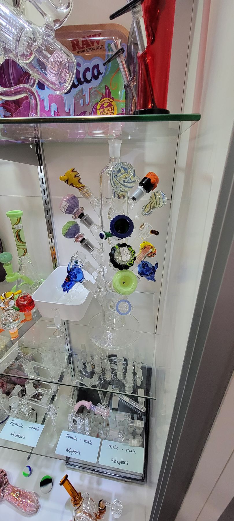Glass bongs and accessories in a display case.