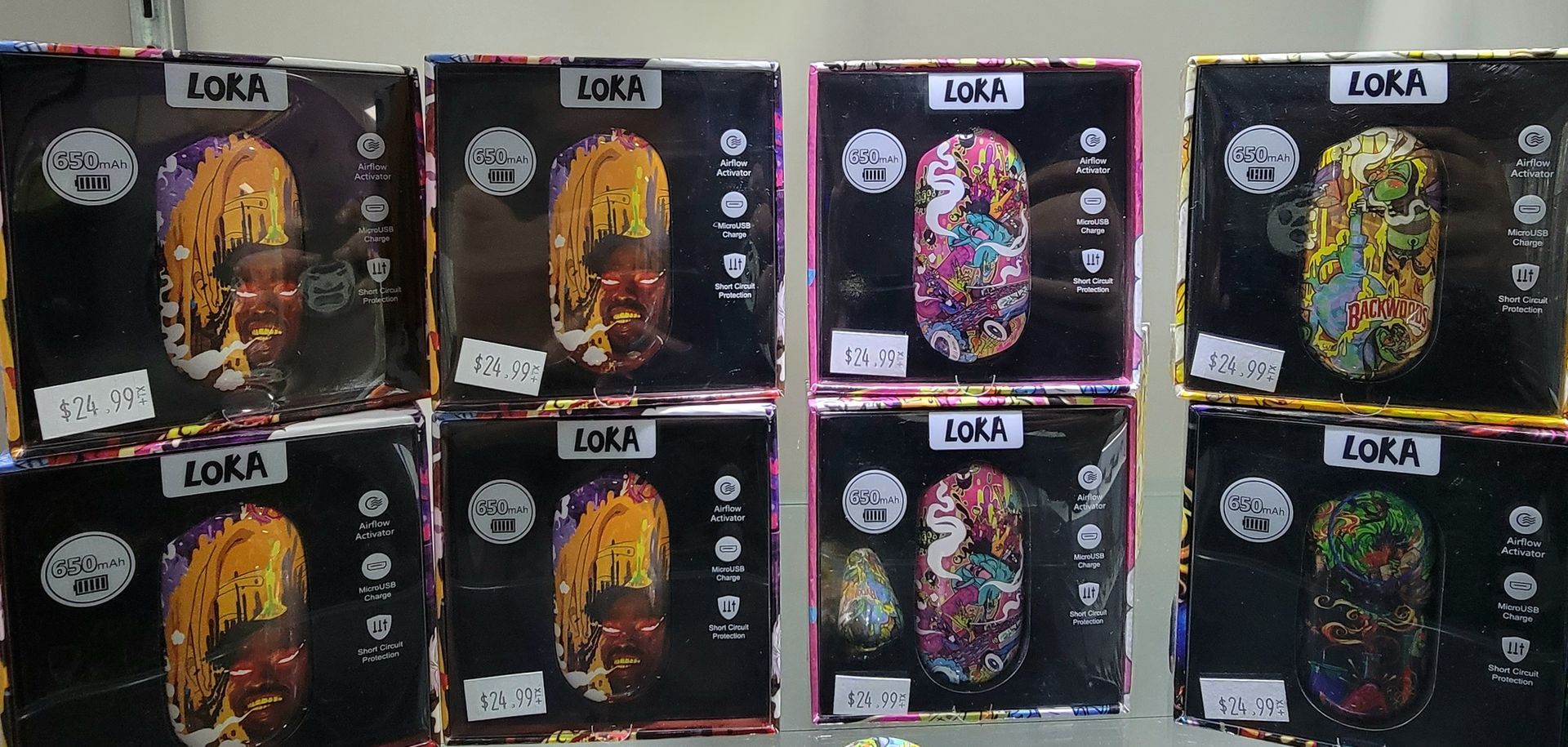 Boxes of Zora brand vape pens on a shelf, various colors.