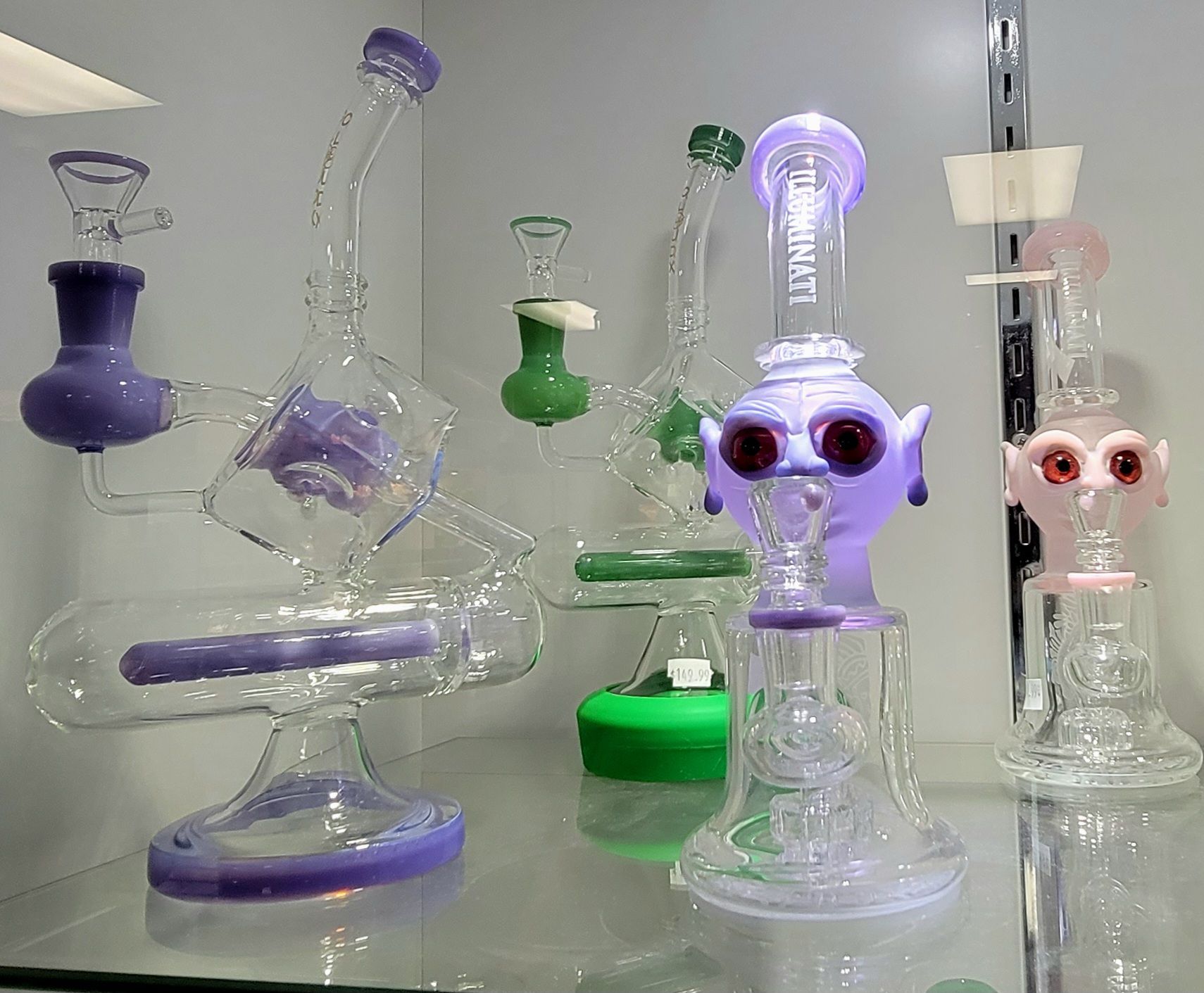 Display of glass water pipes in various colors and designs, for sale in a shop.