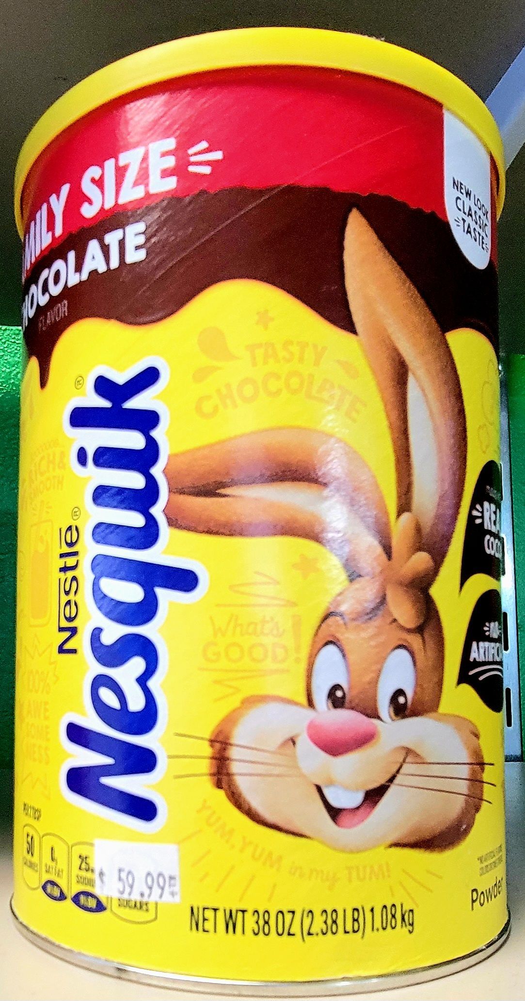 Nesquik chocolate powder container with the cartoon rabbit, yellow background.