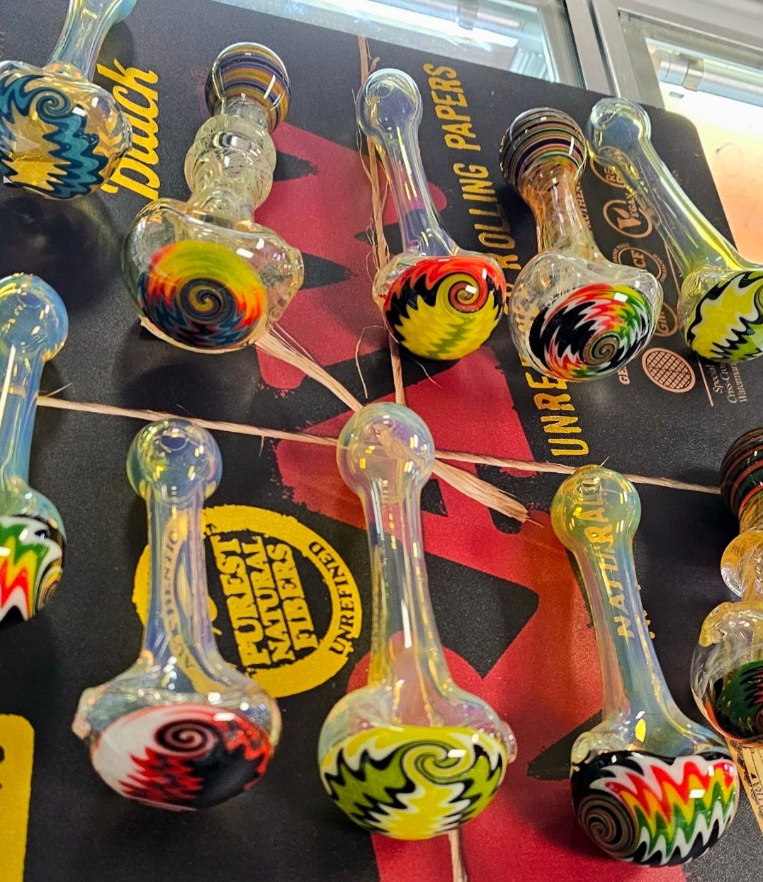 Colorful glass hand pipes on display.