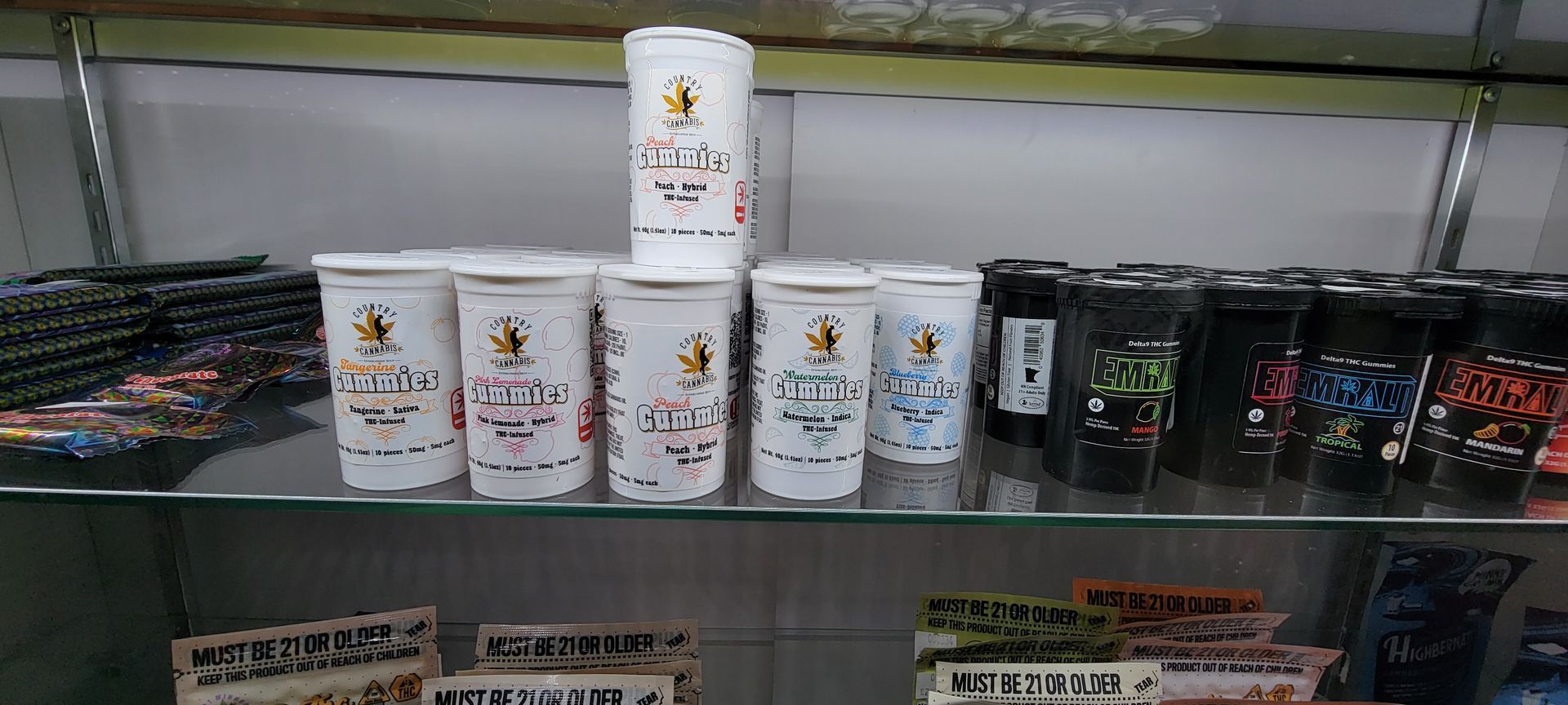 Shelves with various cups of different colors and designs in a store.